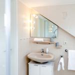 Bathroom with sink, mirror, and shower area