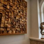 Wand mit Holzblockdekoration und zwei Seepferdchenfiguren auf Fensterbank.