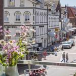 Balkon mit Blumen und Beeren über einen belebten Straßenmarkt in einer Stadt