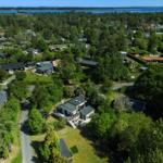 Aerial view of vacation homes in green surroundings with water view