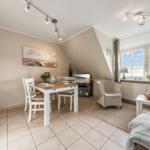 Living space with dining area, sleeping space, and windows with a view.