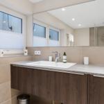 Bathroom with sink, mirror, and shower