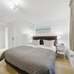 Bedroom with double bed, nightstands, and window