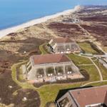 House with green roofs and view of beach and sea