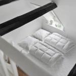Bedroom with double bed, window, and black beams.