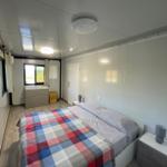 Bedroom with double bed, window, and nightstands.