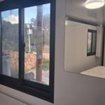 Bedroom with window and mirror on the wall