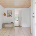 Entrance area with wooden ceiling, tiled floor, and door to outdoor area.