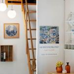 Living space with wooden ladder, wall art, and decorative shelves.