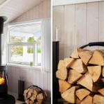 Kaminofen mit Holzstapel in rustikalem Raum mit Holzwand und Fenster.