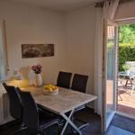 Esszimmer mit Tisch, Stühlen und Blick auf den Garten.