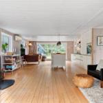 Living area with fireplace, kitchenette, and seating.