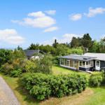 Modern house with large garden and view of the coast.