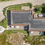 House with terrace, garden, and pool area viewed from above.