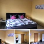 Schlafzimmer mit Bett, Nachttischen und Wandbildern. Kleine Fläche mit Schrank und Tür.