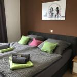 Schlafzimmer mit Bett, Kissen und Bild an der Wand.