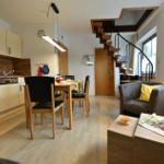 Küche, Essbereich und Wohnzimmer mit Holzboden und Treppe.
