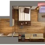 Schlafzimmer mit Bett, Wohnbereich mit Sofa und Küche. Dusche und Toilette sind vorhanden.