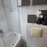 Badezimmer mit Dusche, Toilette und Wanddekoration.
