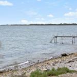 Rocky shore with pier and stairs into the water