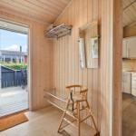 Entryway with high chair, drying rack, and view to the terrace.