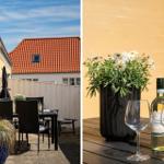 Terrasse mit Tisch, Stühlen und Blumen. Flasche Wein und zwei Gläser auf Tisch.