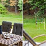 Terrace with table, chairs, and plant. Garden with wooden toy and grass.