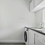Kitchen with washing machine, dishwasher, and sink.
