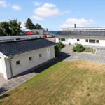 Modern white house with garage and garden. View of the sea.