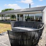 Modern villa with large garden and terrace with rattan furniture.