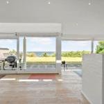 Living area with view of the beach and garden. Terrace with grill and table.