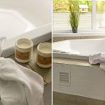 Badewanne mit Handtüchern und Kerzen. Fensterblick auf Garten.