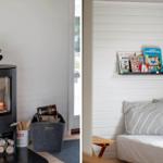 Kamin mit Brennholz und Bücherregal mit Kinderbüchern an der Wand.