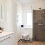 Bathroom with shower, toilet, and sink with mirror