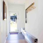 Entrance area with wooden rack, flooring, and door to the outside.
