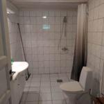 Bathroom with shower, toilet, and sink.