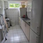 Kitchen with refrigerator, washing machine, and window