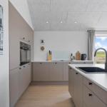 Modern kitchen with integrated oven and view of a green landscape.
