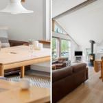 Living area with wooden table, leather sofa, and wood stove under high ceiling.