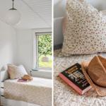 Bedroom with window, bed, and wall picture. Hat and book on bed.
