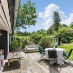 Deck with seating and view of green garden