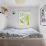 Bedroom with bed, window, and wall art.