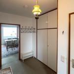 Entryway with coat rack, closet, and view into dining room