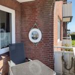 Terrace with chair, table, and lifebuoy on the wall