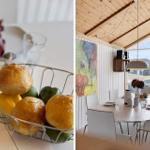 Esszimmer mit Holzdecke und großem Fenster. Tisch mit Stühlen und Obstschale.