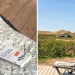 Ein Buch liegt auf einem gemusterten Kissen. Im Hintergrund eine Terrasse mit Blick auf Dünen.