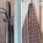 Duschbrause und Handtuch an der Wand