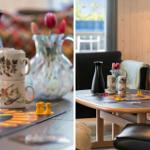 Tisch mit Spielplatte, Tassen und Blumen in einem Wohnzimmer mit Holzwand und Sitzgelegenheiten.