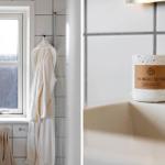 Badezimmer mit Fenster, Bademantel und Kerze auf Waschbecken.