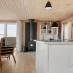 Küche mit Essbereich, Holzdecke, Kamin und Fenster mit Blick.
